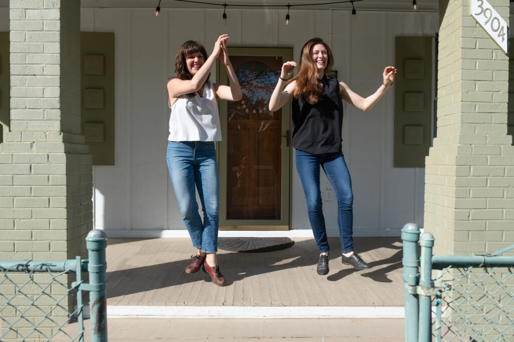 Becky Hill and Kate Spanos dancing on porch